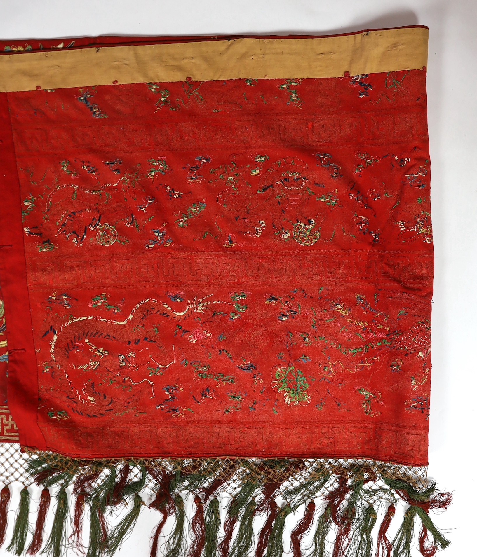 A Chinese embroidered silk ‘dragon, phoenix and lion’ panel or table frontal, late Qing dynasty, 117cm x 337cm